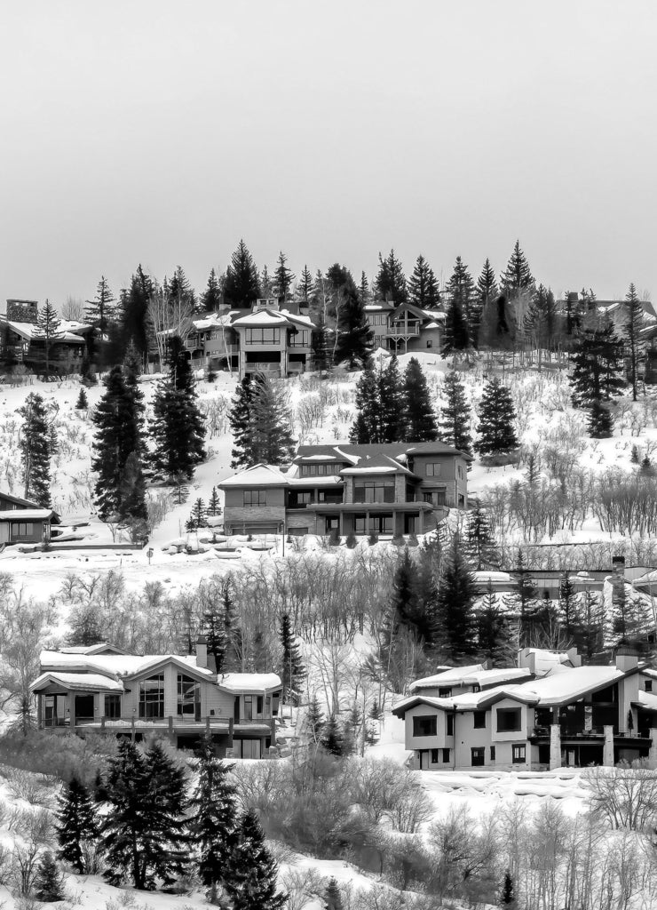 Square crop Park City Utah neighborhood in winter with colorful homes on snowy hill top in black white