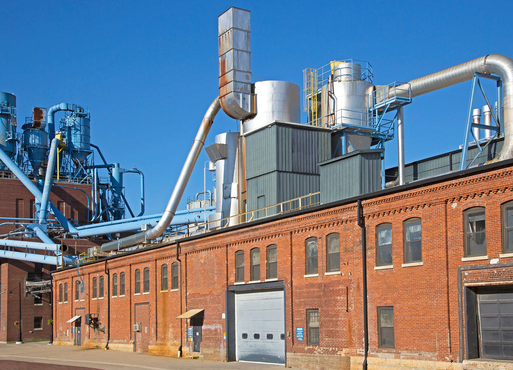 A manufacturing plant in the historic Millwork District of Dubuque under a blue sky on a warm day, Iowa USA