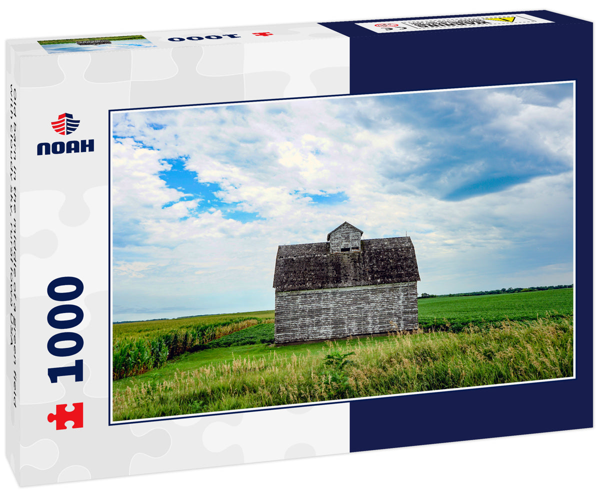 Old barn in the middle of a green field with cloudy sky, rural Iowa USA