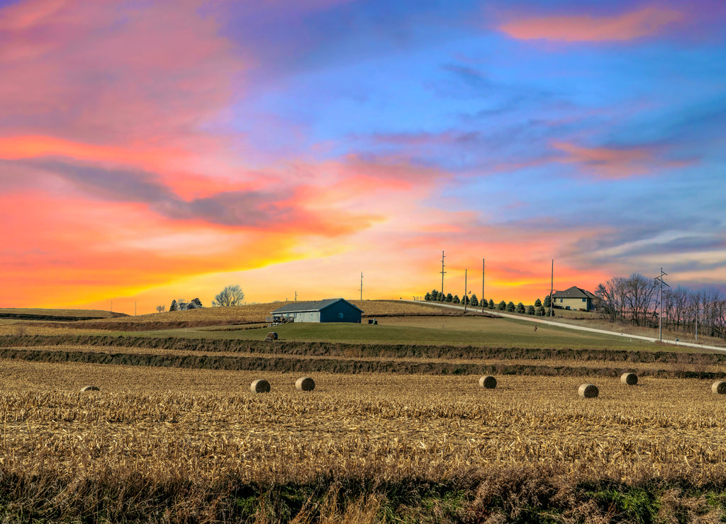 Twilight sunset over a golden field in the middle of Iowa along route 80 in the USA