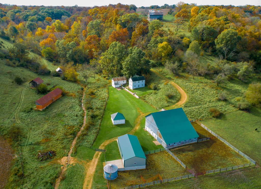 Aerial farmstead rural Iowa along creek and fall colors