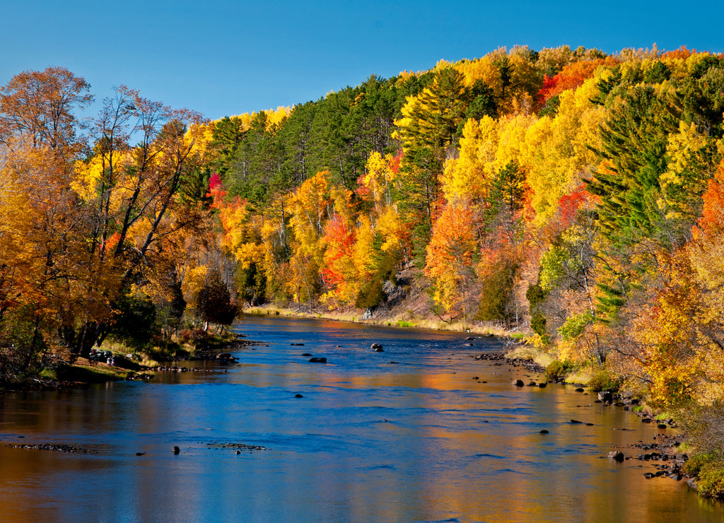 Vivid autumn colors reflected in the Paint River at Crystal Falls, Michigan