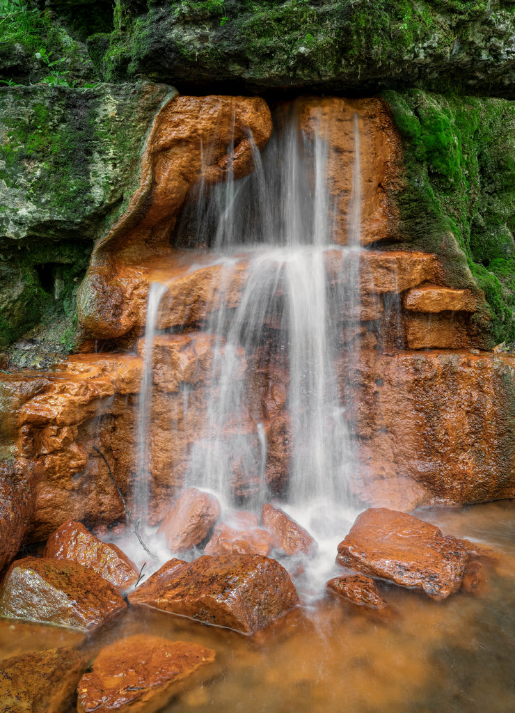 Water from The Yellow Spring - The Yellow Spring gushes water from an outcropping of rocks, stained orange yellow from high iron content, at Glen Helen Nature Preserve in Greene County, Ohio