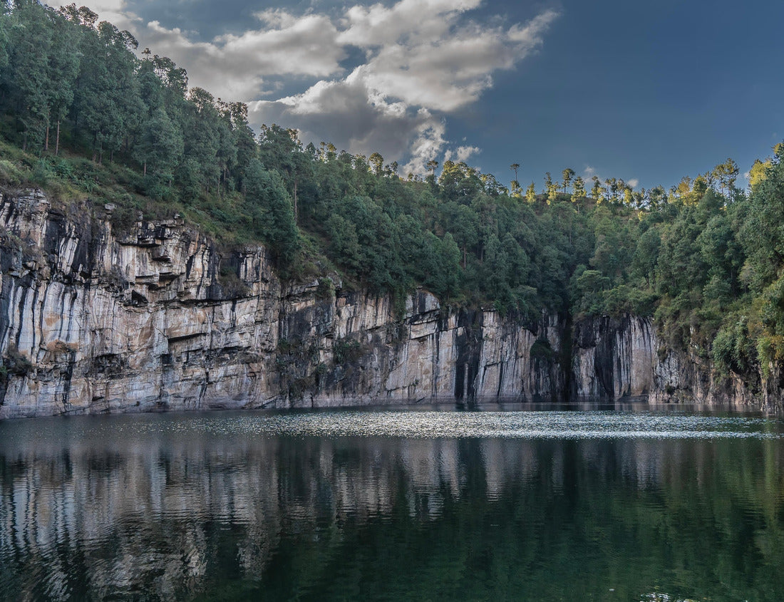 Noah Jigsaw Puzzle A beautiful emerald lake in the crater of an extinct volcano is surrounded by steep cliffs. Coniferous forest on the banks. Reflection on calm water. Clouds in the blue sky. Tritriva lake. Madagascar 1000 pieces