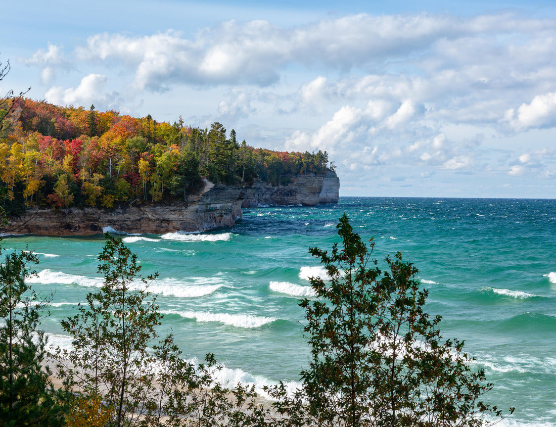 Noah Jigsaw Puzzle A forest in the Upper Peninsula creates a fall background at Chapel Beach in northern Michigan. Lake Superior crashes on the beach, white puffy clouds obscure the blue sky 1000 Pieces