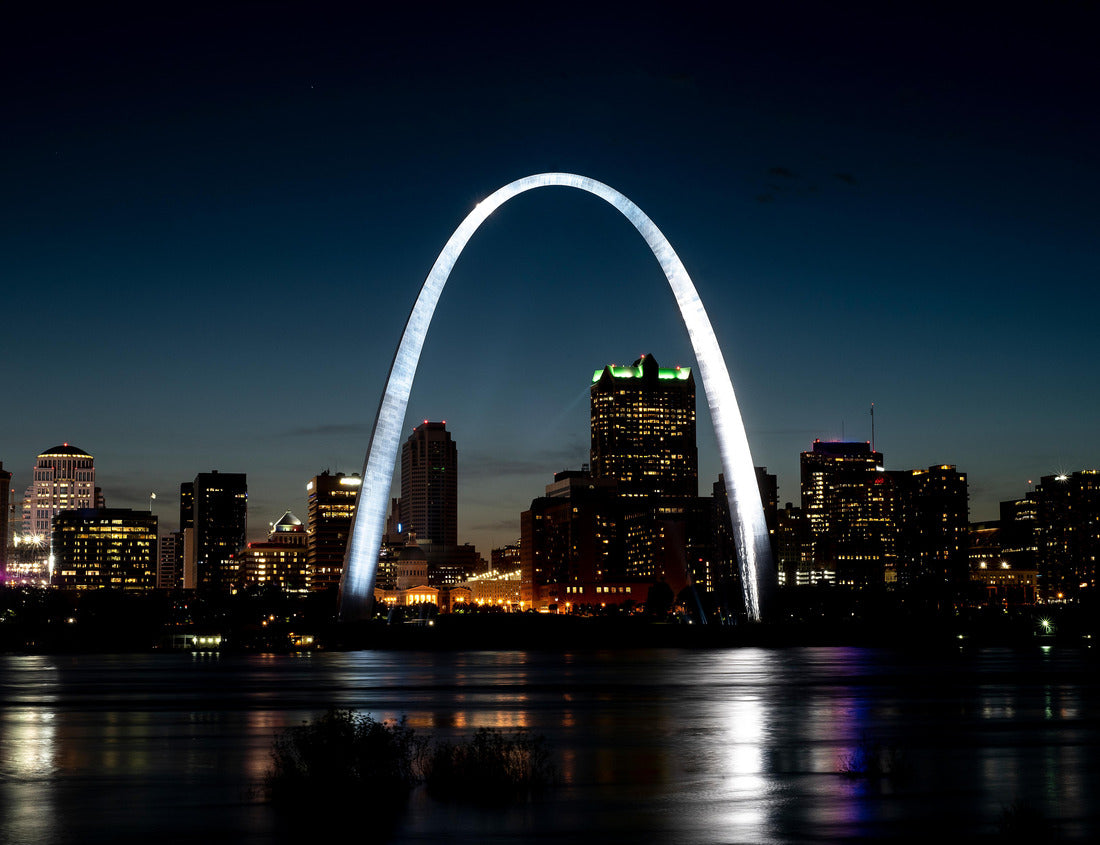 St. Louis gateway arch reflecting shining light at night on Mississippi River in foreground, tall office buildings and skyline in background 1000pc Puzzle