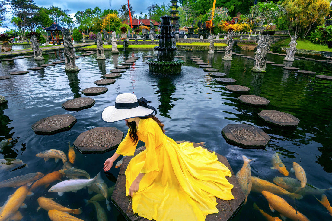 Woman feeding colorful fish in pond at Tirta Gangga Water Palace in Bali, Indonesia 2000pc Puzzle