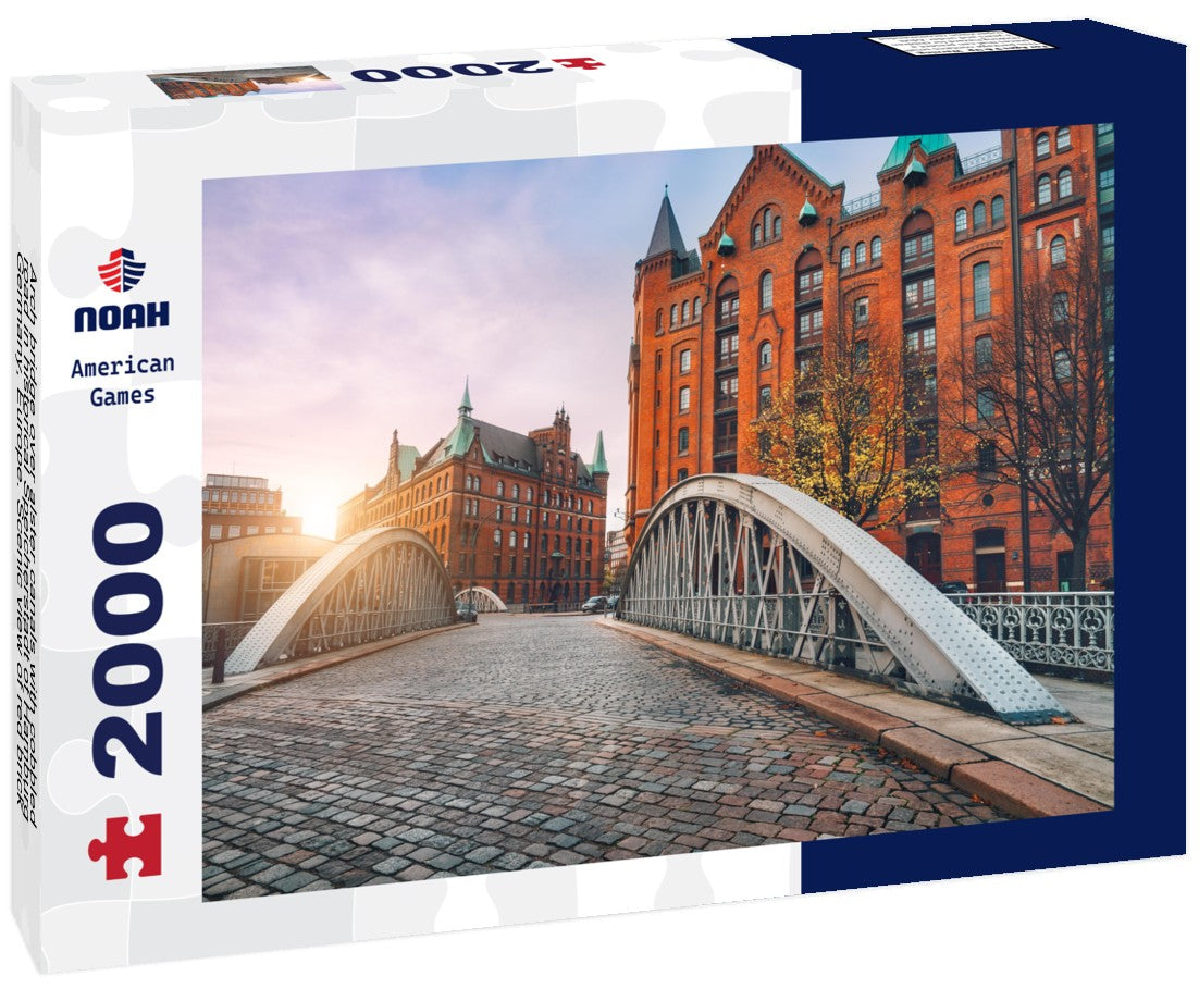 Arch bridge over alster canals with cobbled road in historical Speicherstadt of Hamburg, Germany, Europe. Scenic view of red brick building lit by golden sunset light 2000pc Puzzle