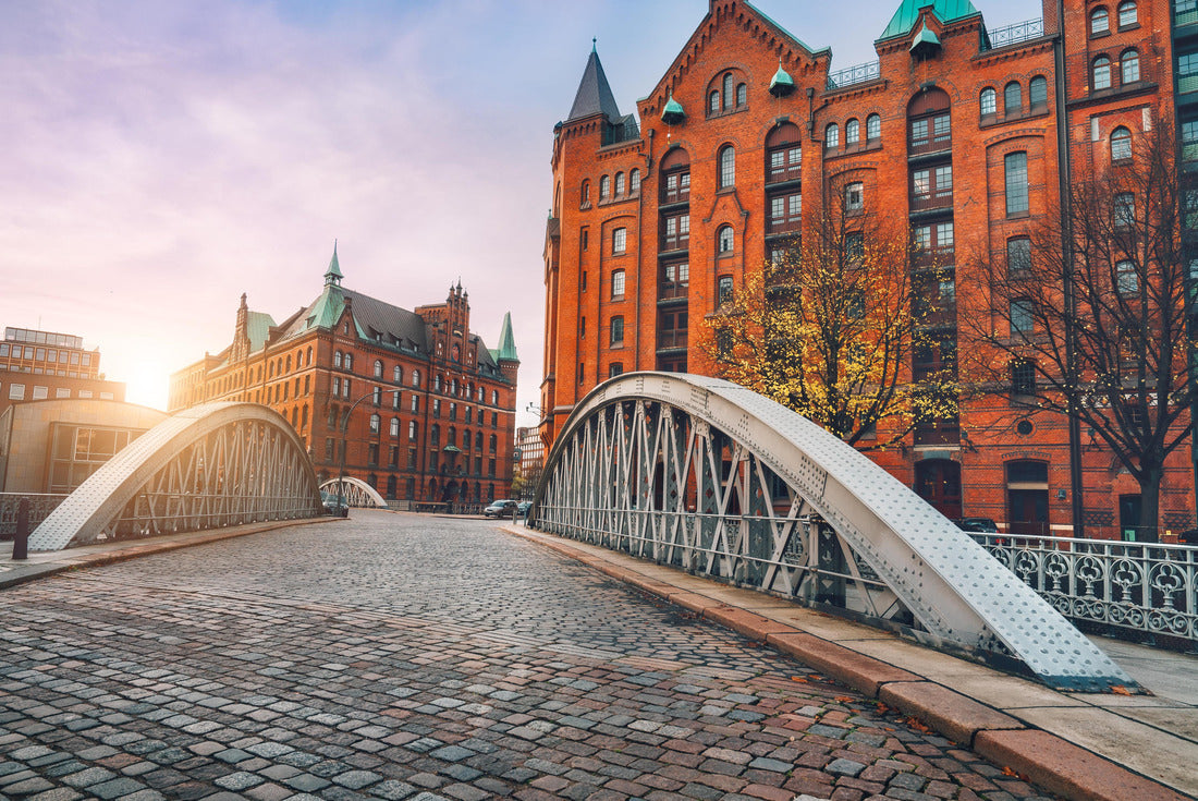 Arch bridge over alster canals with cobbled road in historical Speicherstadt of Hamburg, Germany, Europe. Scenic view of red brick building lit by golden sunset light 2000pc Puzzle