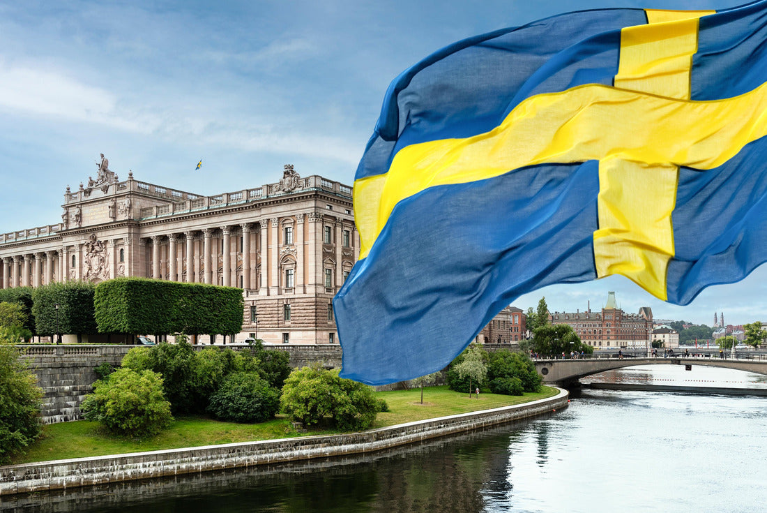 Swedish Parliament (Riksdag) and the Riksbank bridge over the Lilla Vartan river with the Swedish national flag in the foreground 2000pc Puzzle