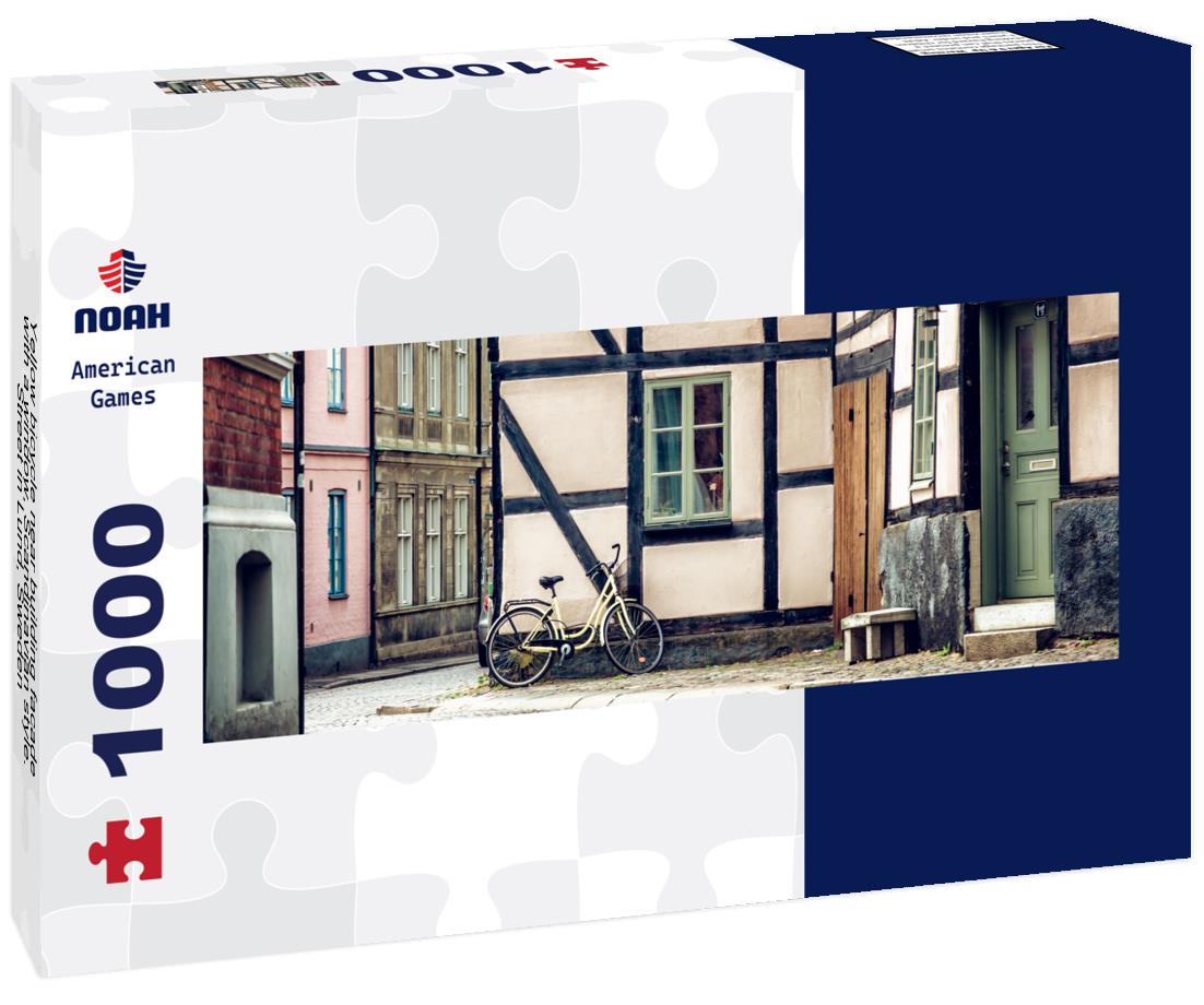 Yellow bicycle near building facade with a window, Scandinavian style. Street in Lund, Sweden 1000pc Panoramic Puzzle