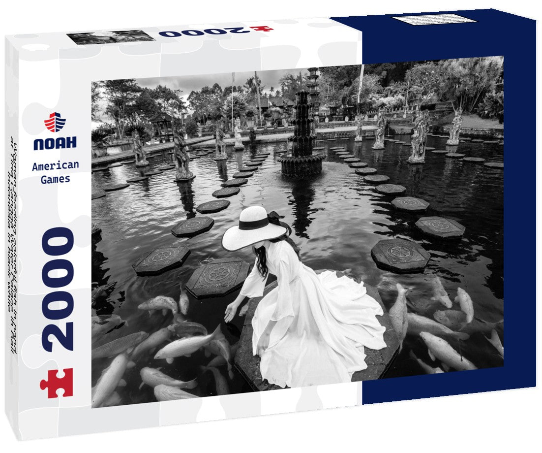 Woman feeding colorful fish in pond at Tirta Gangga Water Palace in Bali, Indonesia 2000pc PuzzleBlack and White