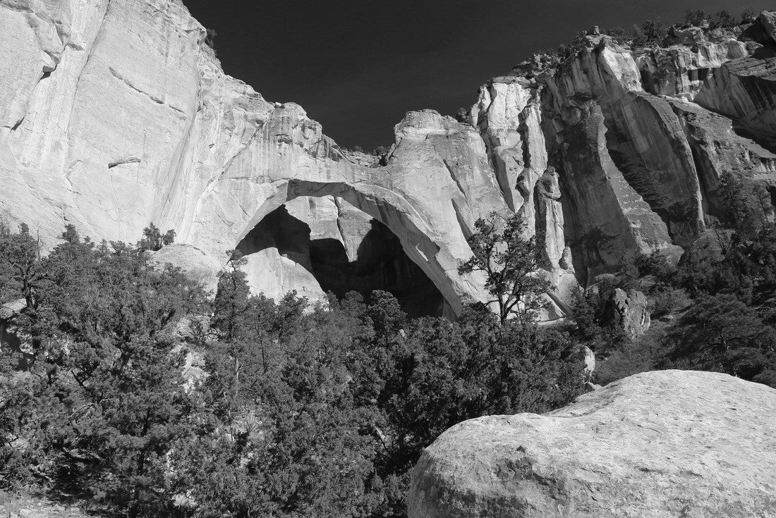 La Ventana Natural Arch in El Malpais National Monument in New Mexico casting a shadow on background sandstone cliffs with vivid blue sky and saturated light of late day sun 2000pc PuzzleBlack and White