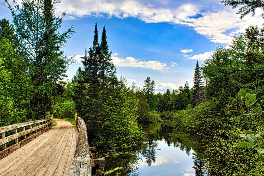A curving wooden bridge oases alonmgside a river and through a lush green forest on the Bearskin Trail in Northern Wisconsin 2000pc Puzzle