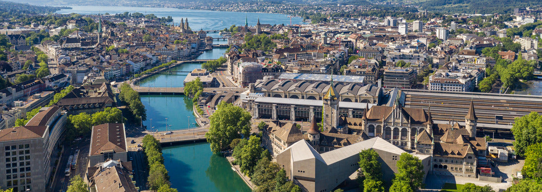 Noah Jigsaw Puzzle Aerial view of the Limmat River flowing through downtown Zurich, Switzerland, passing the National Museum, the train station and the old town, and emptying into Lake Zurich on a sunny summer's day panorama 1000 pieces