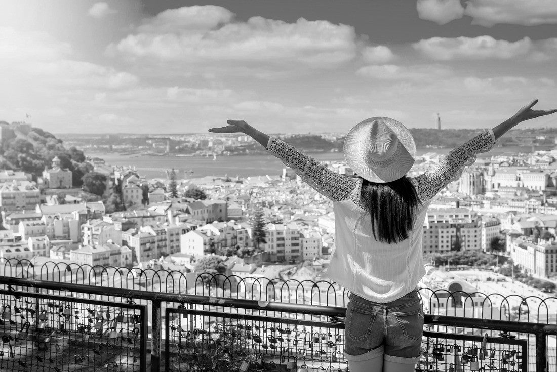 A happy tourist woman overlooks the colorful old town Alfama of Lisbon city, Portugal, and castle Sao Jorge on her sightseeing trip 2000pc PuzzleBlack and White