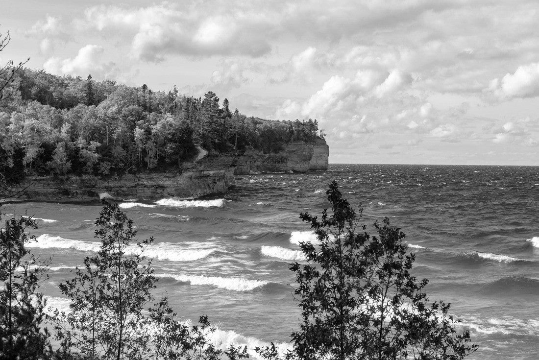A forest on the Upper Peninsula creates an autumn backdrop at Chapel Beach in northern Michigan. Lake Superior crashes onto the beach, puffing clouds of white across the blue sky 2000pc PuzzleBlack and White