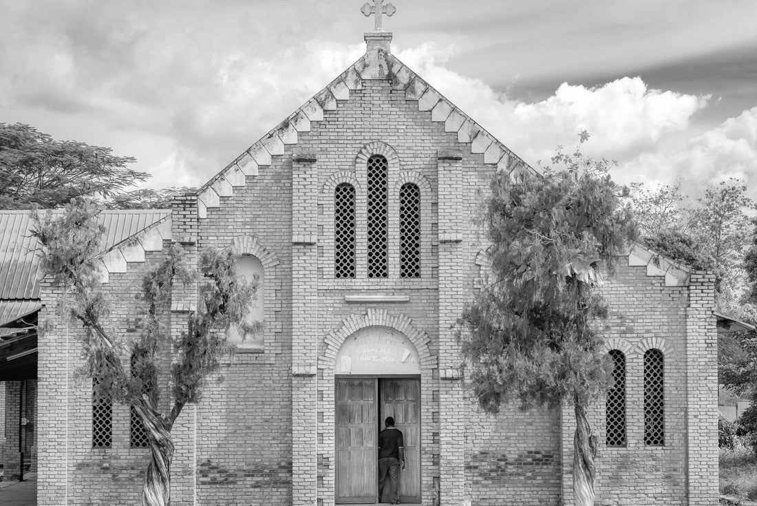 Noah Jigsaw Puzzle African man stepping into the doorway of a small church at the Cathedral Bangui, Notre Dame, famous church in the Central African Republic in black white 2000 pieces