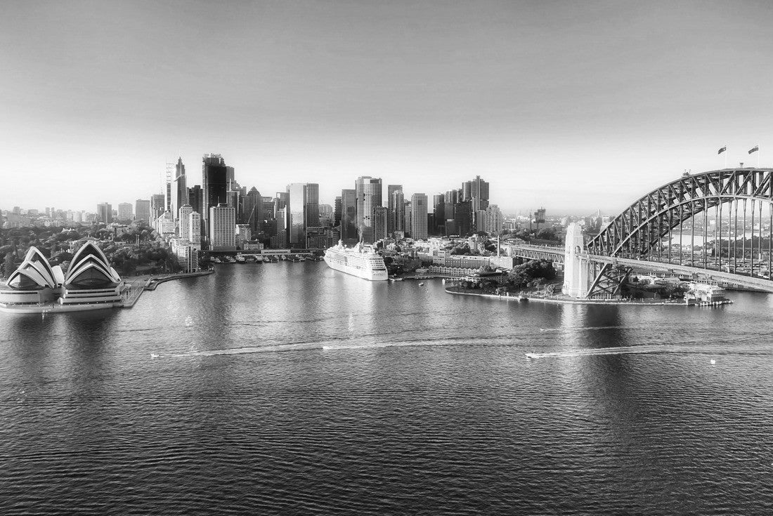 Arch of the Sydney Harbour bridge across Sydney harbour to The Rocks and Circular quay waterfront of city CBD lit by soft morning light between blue waters and sky 2000pc PuzzleBlack and White
