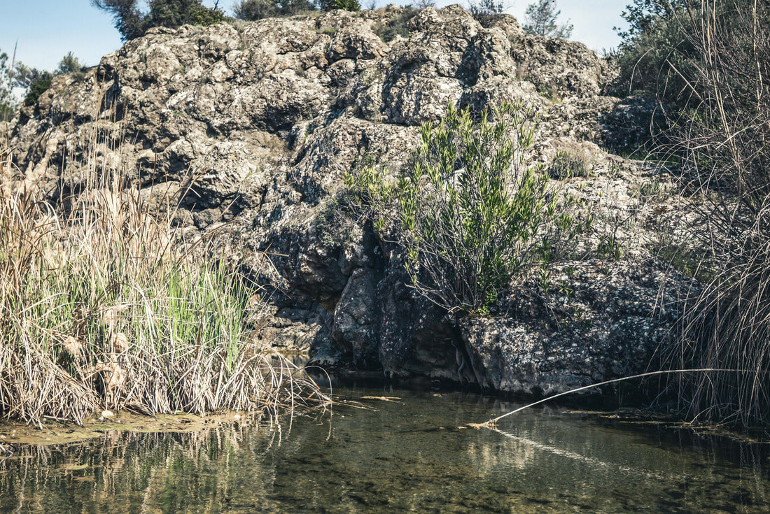 Clear Water in the River Vathy Argaki with Stones at the Bottom Feeding the Dipotamos Reservoir in the Potamos National Park surrounded by Reeds and Gray Rocks (Kornos, Larnaca District, Cyprus) 2000pc Puzzle