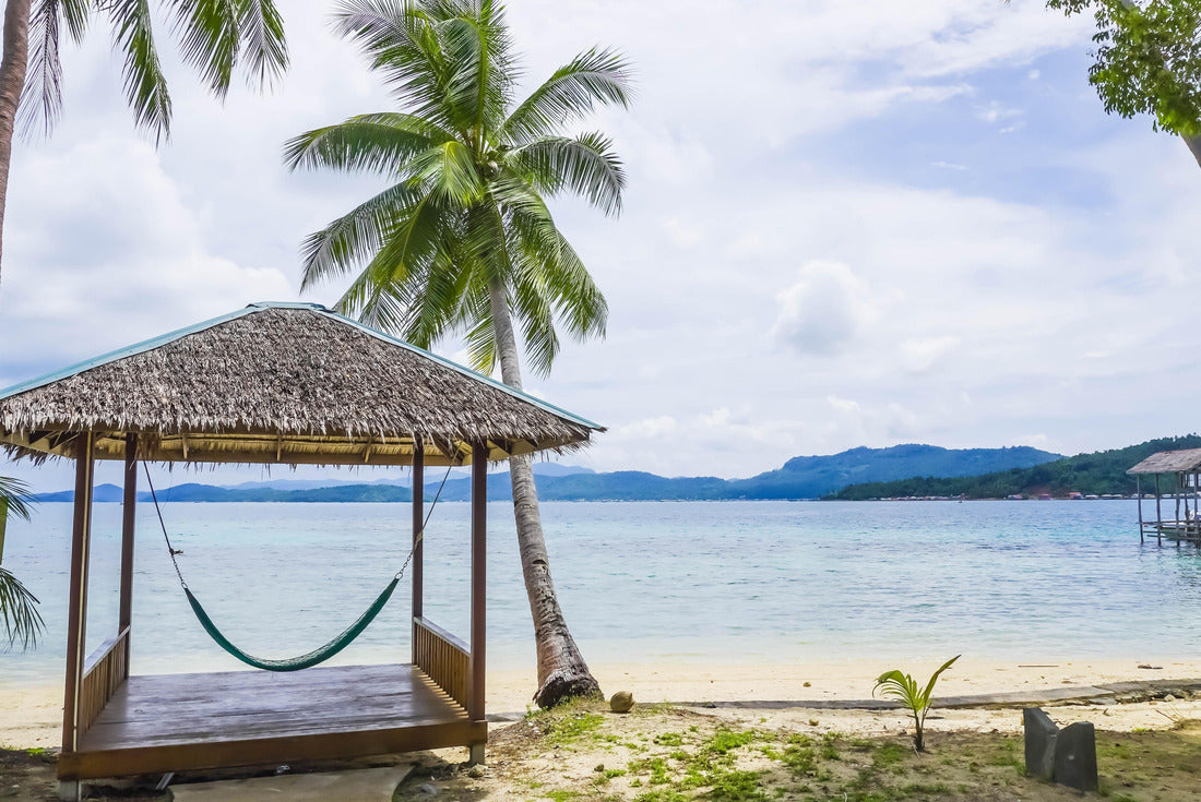 Tropical summer beach resort with palm, coconut trees, and hammock in Piugus Island, Anambas, Indonesia on a beautiful summer day with colorful ocean waters, pristine sands and cloudy sky. Copy space 2000pc Puzzle