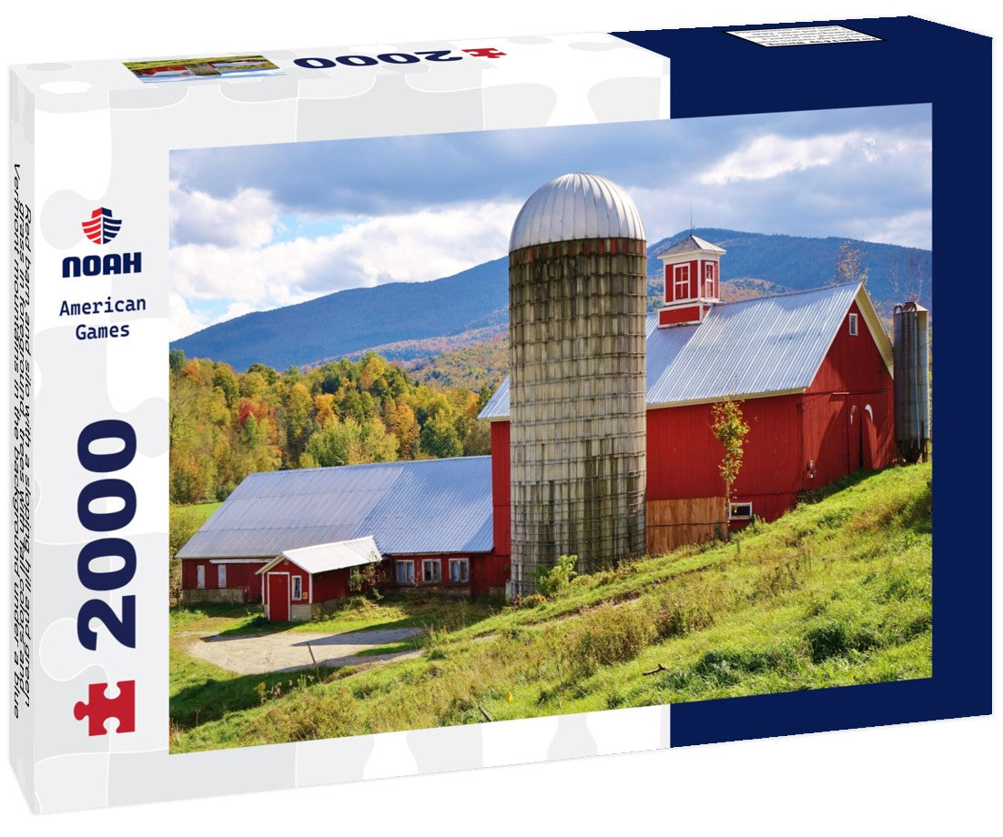 Red barn and silo with a sloping hill and green grass in foreground, trees with fall colors and Vermont mountains in the background under a blue and cloudy sky on a nice autumn day 2000pc Puzzle