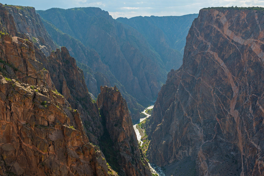 Steep granite cliffs of the Black Canyon of the Gunnison with the two dragons and the mysterious Gunnison River cutting through the rock in the valley, Colorado, USA 2000pc Puzzle
