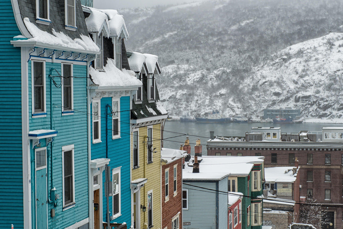 A very steep street in St. John's, Newfoundland, on a foggy winter's day, with bright colored row houses descending down the road. There's snow on the hillside in the background and a smooth harbor 2000pc Puzzle