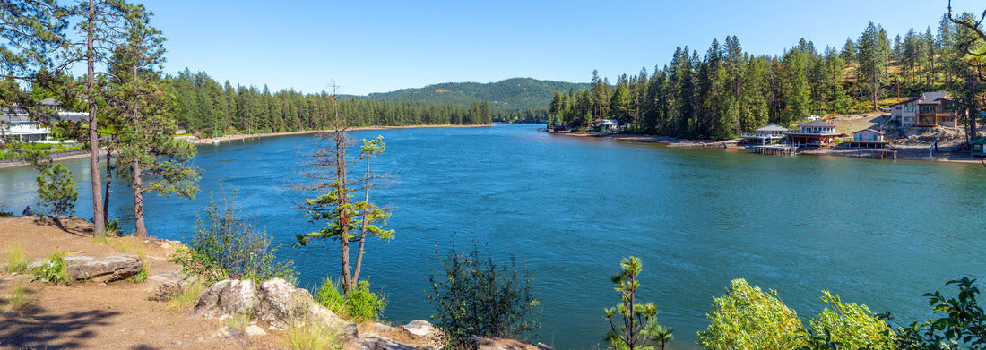 The Spokane River at Post Falls, Idaho, with homes on the shore near Black Bay Park on a summer day 1000pc Panoramic Puzzle