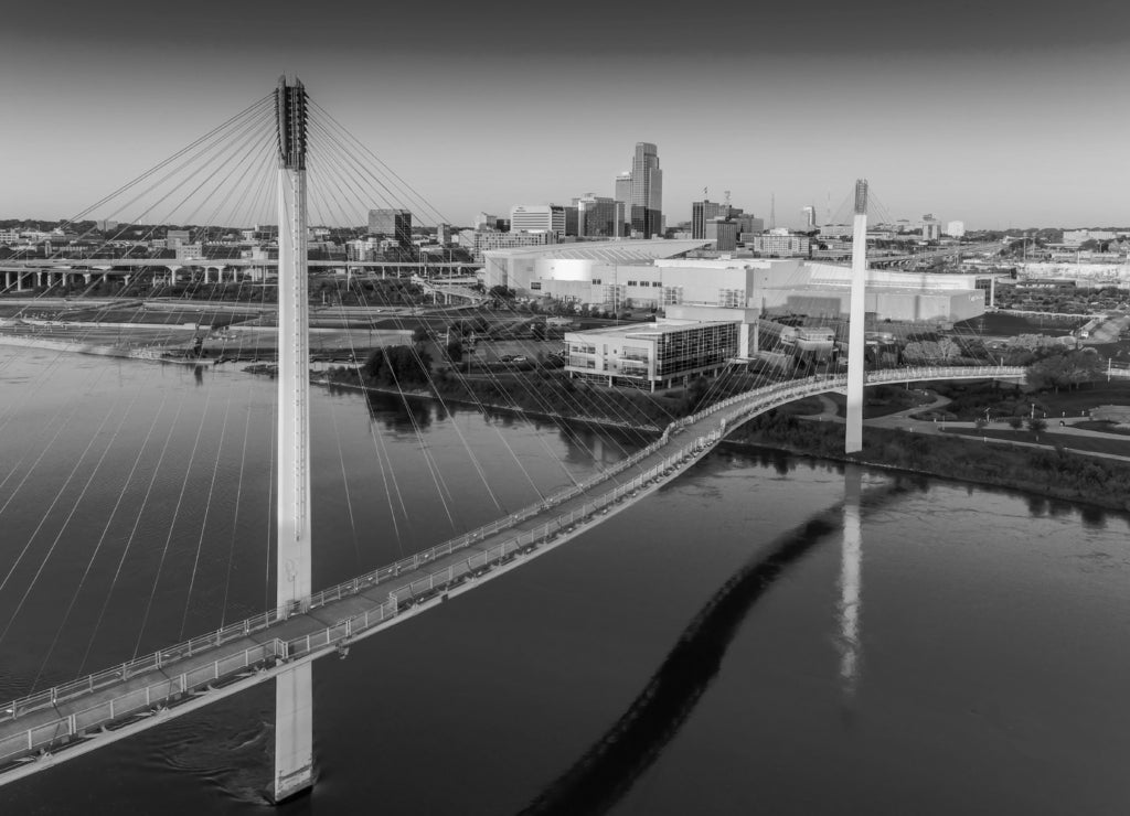 Bob Kerry Pedestrian Bridge spans the Missouri river with the Omaha Nebraska skyline in black white