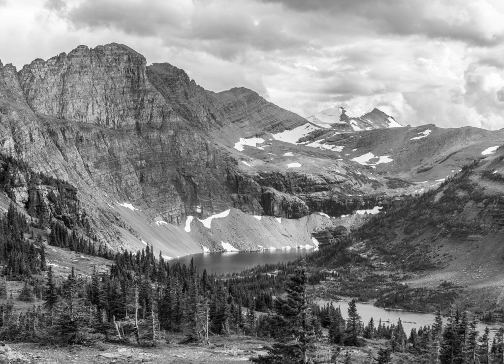 The hidden lake and mountains in Glacier National Park, in Montana, on a cloudy day. in black white