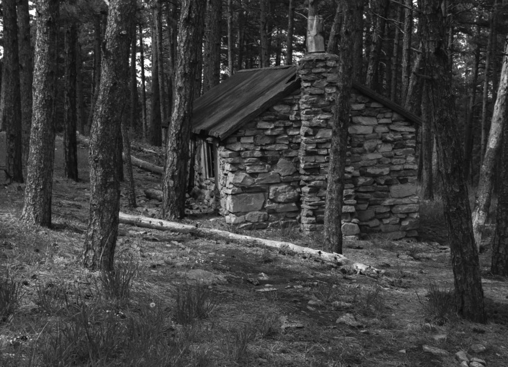 Stone cottage in the woods, city of Boulder Colorado USA in black white