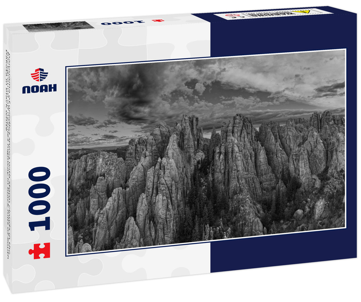 panorama of needles spires with storm clouds in the background off needles highway in black hills of South Dakota in black white