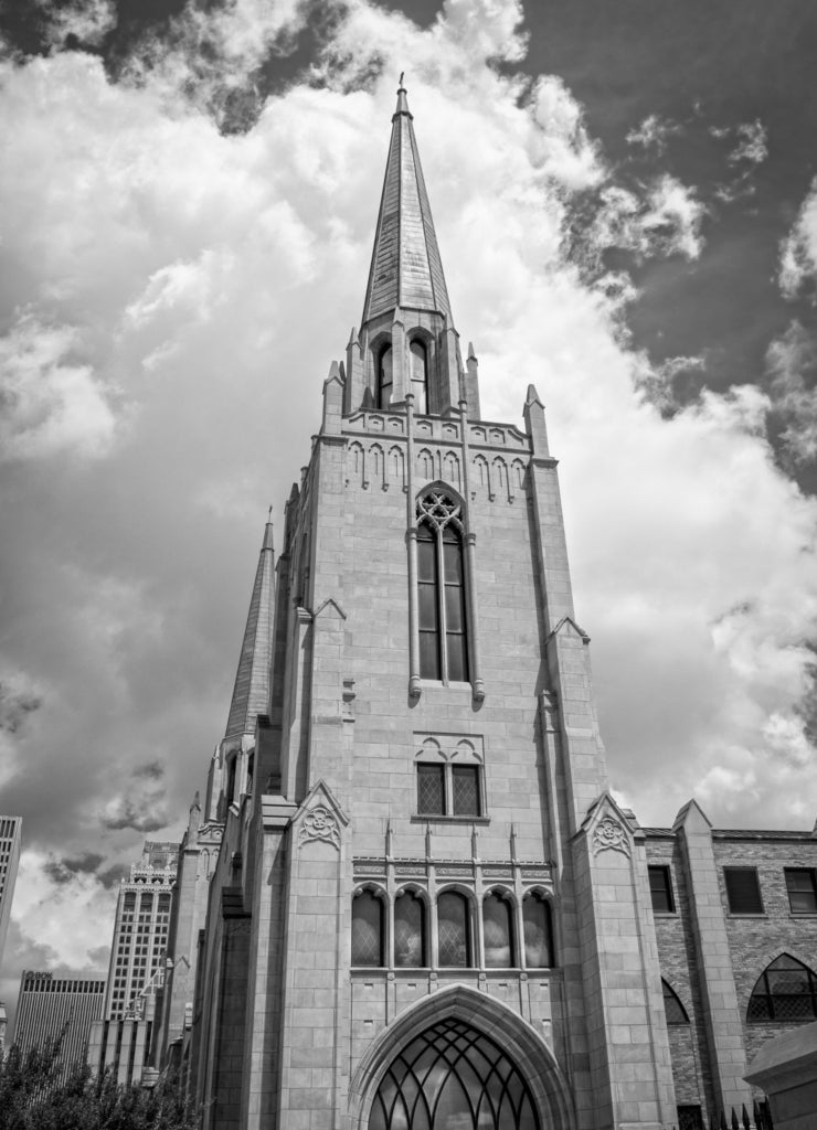 Cityscape of Tulsa Oklahoma USA with gothic chruch with copper spires in foreground in black white