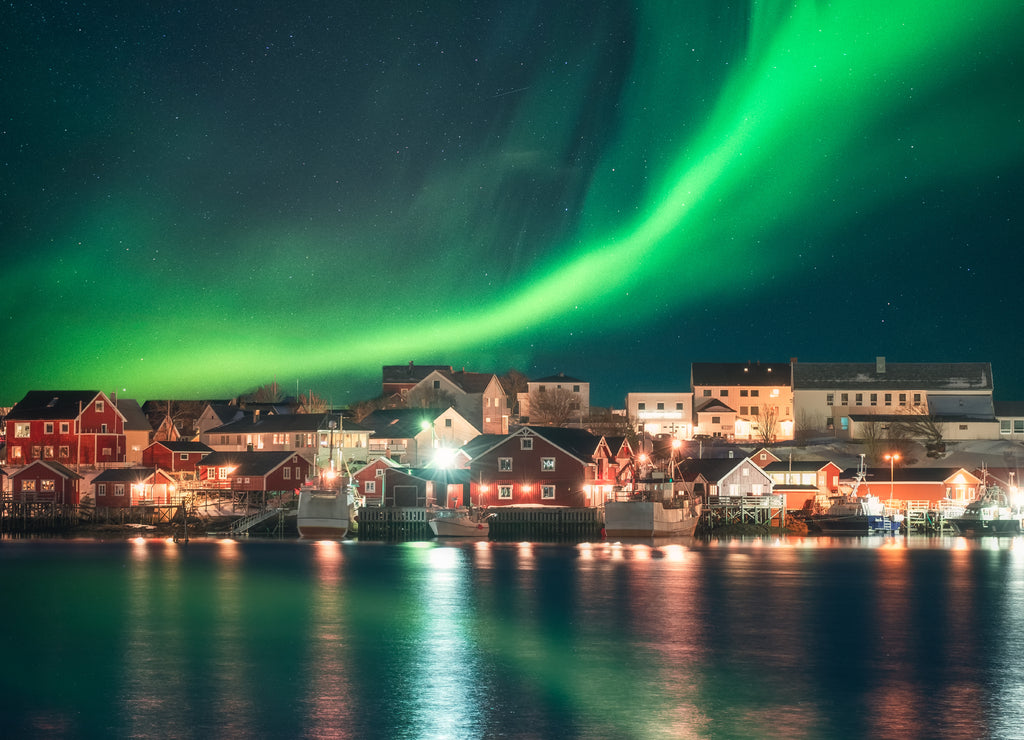 Northern light over fishing village in Lofoten