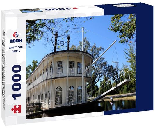 Noah Jigsaw Puzzle Double decker, paddle boat serves as a visitor's center for Greenville, Mississippi. Boat is white with black trim and floats on water 1000 pieces