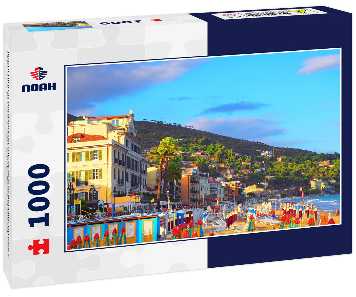 Multicolored parasols on the beach in Alassio, province of Savona, Sanremo region, Italy. Town at sunset