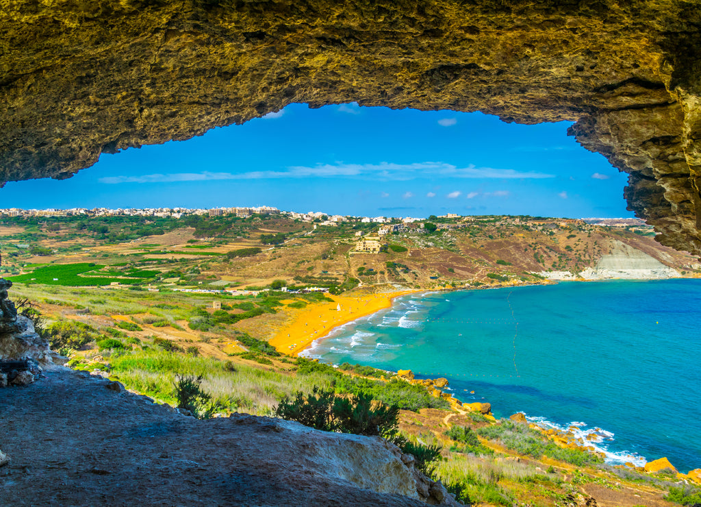 Aerial view of Ir-Ramla Bay in Gozo through the valley Mixta Cave, Malta.