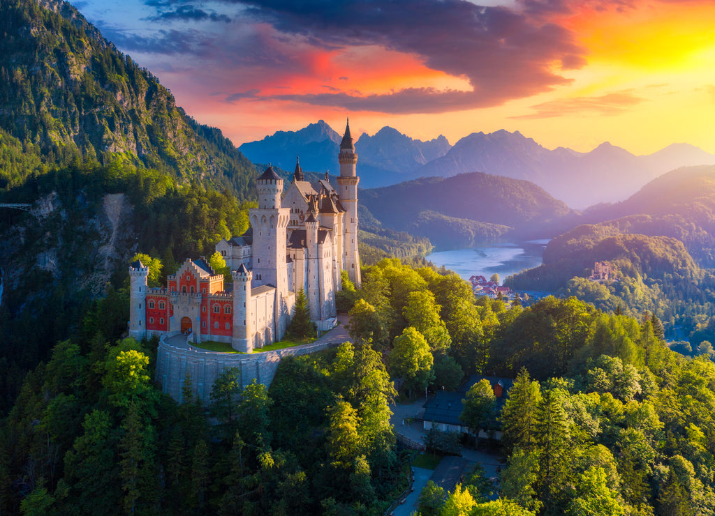 Aerial view of Neuschwanstein Castle with picturesque mountain landscape near Füssen, Bavaria, Germany. Neuschwanstein castle at sunset, Germany