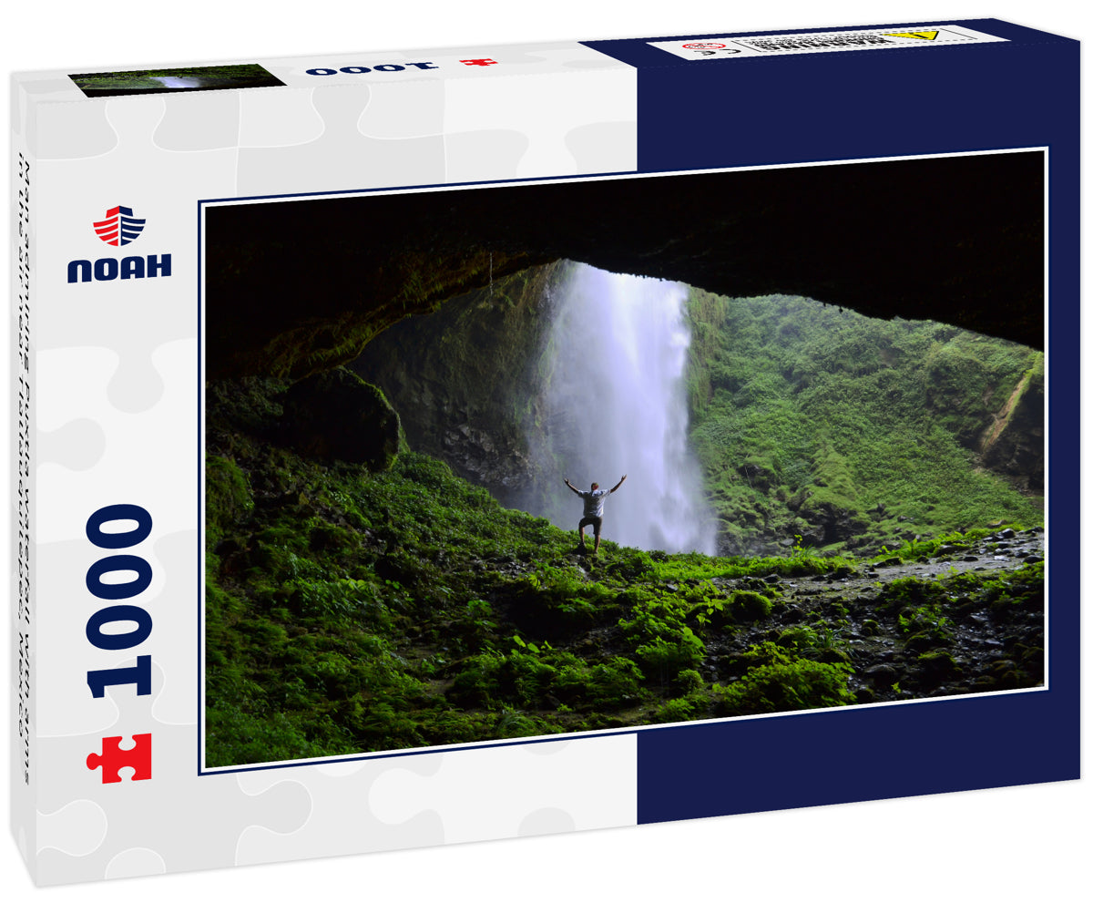 Man admiring Puxtla waterfall with arms in the air near Tlatlauquitepec, Mexico