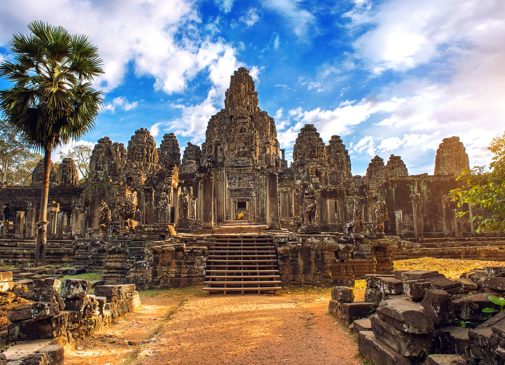 Ancient stone faces at sunset of Bayon temple, Angkor Wat