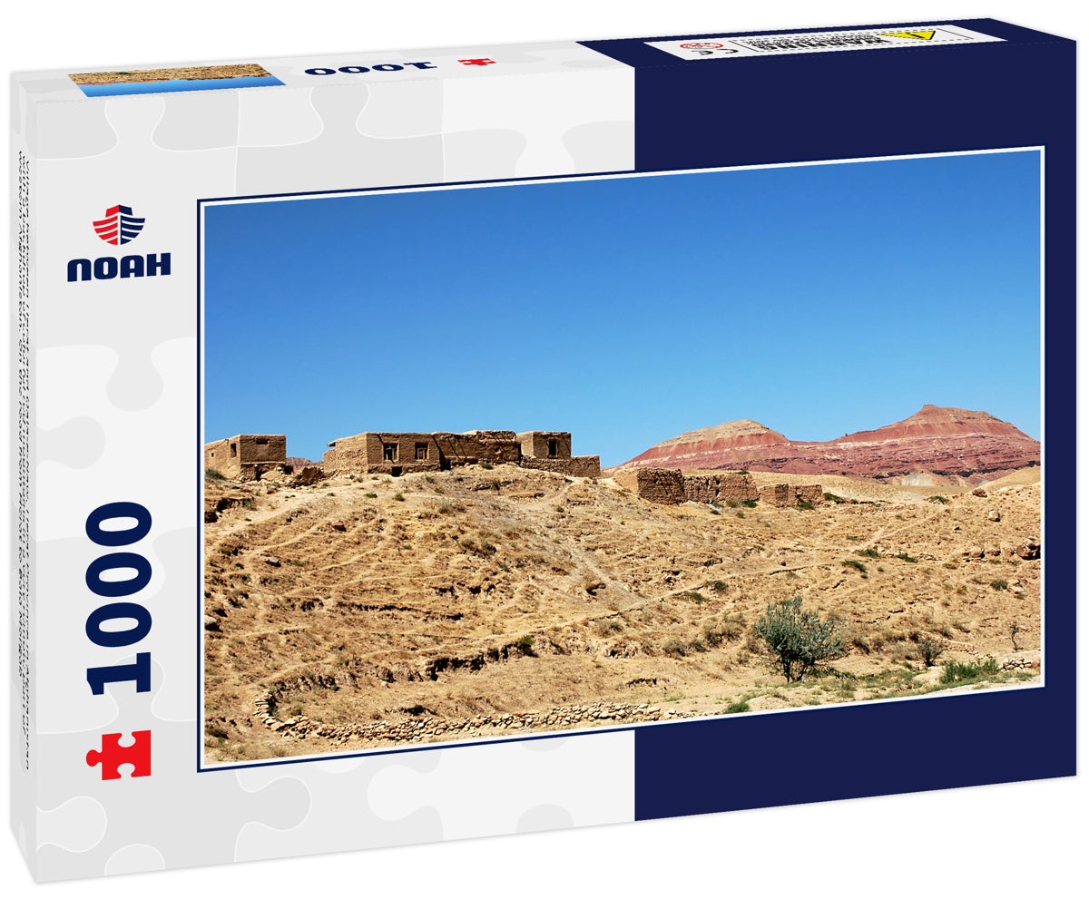 Village between Herat and Qala-e-Naw, Herat Province in Afghanistan with a backdrop of colorful red mountains in a very remote part of western Afghanistan. On the road from Herat to Bala Morgab