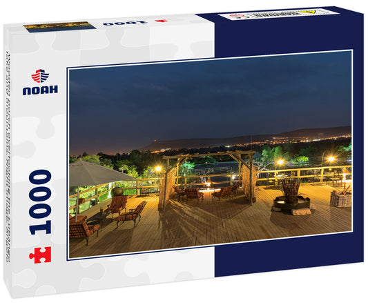 Wooden porch overlooking the Lubango lake and mountains. Night image. Angola