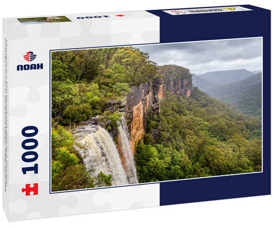 Fitzroy water falls thundering over rock face into forested canyon in Kangaroo Valley, NSW, Australia