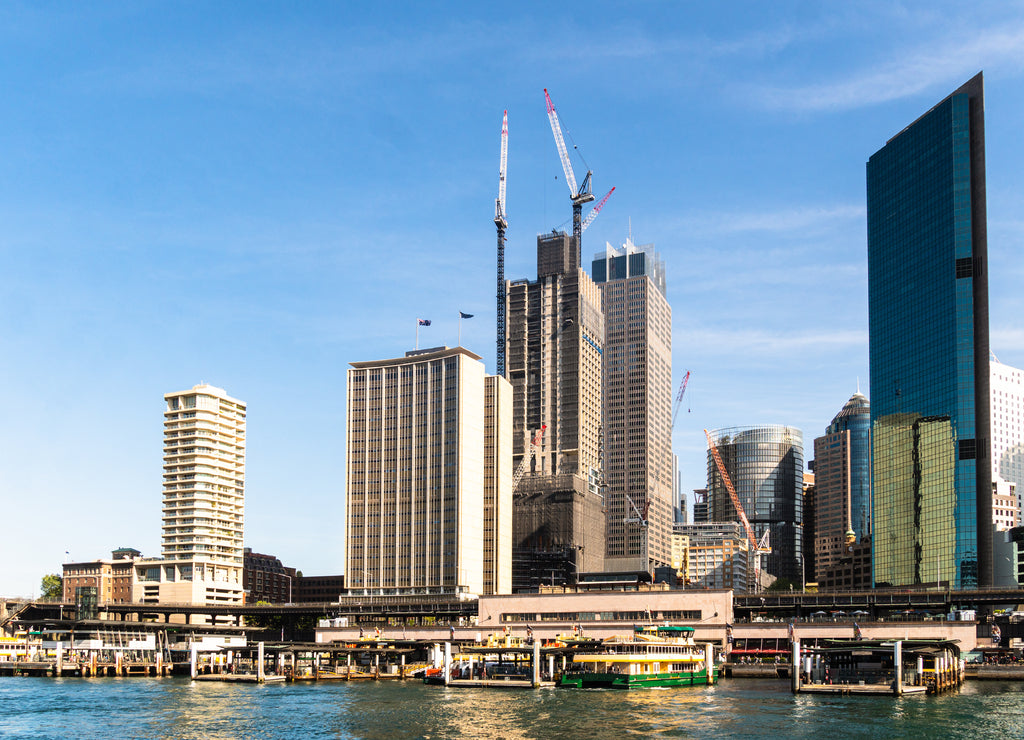 Sunny day over Sydney business district skyline and the Circular Quay ferry terminal in Sydney, Australia largest city