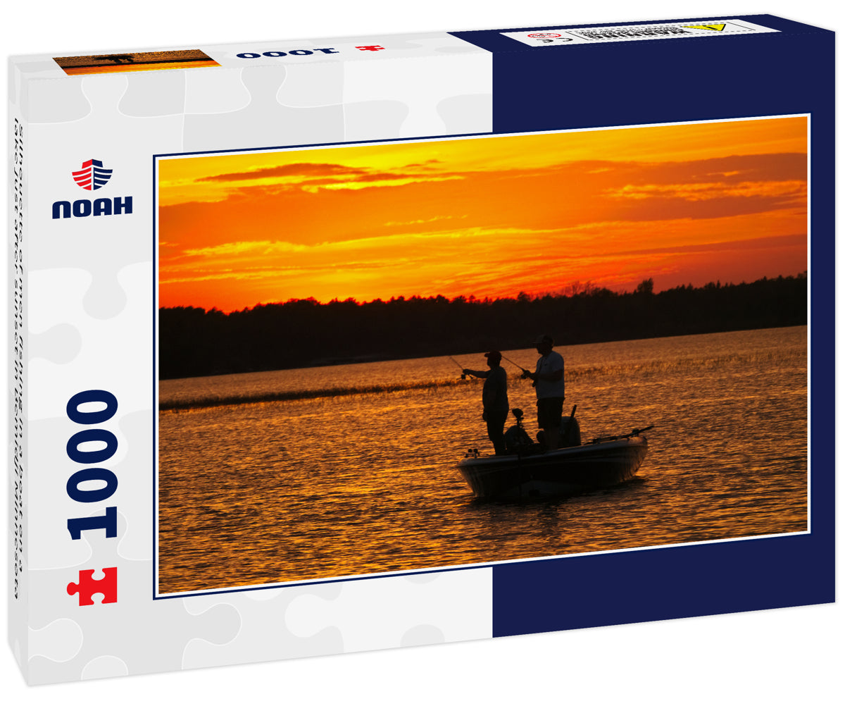 Silhouette of men fishing in a boat on a lake just after sunset in Bemidji Minnesota