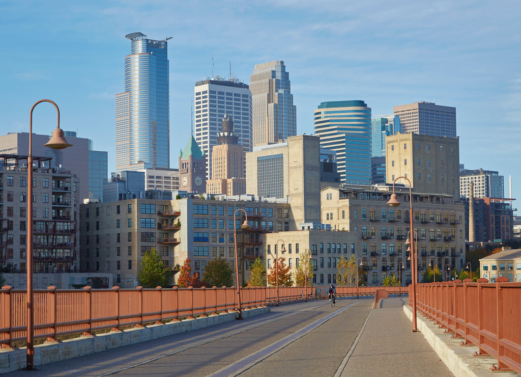 Stone Arch Bridge with downtown Minneapolis Minnesota skyline in the background