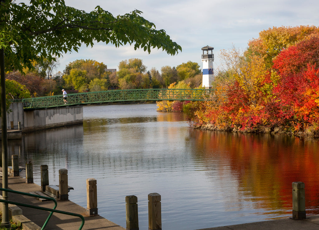 Lighthouse sitting on island with trees turning color at park near downtown Minneapolis Minnesota