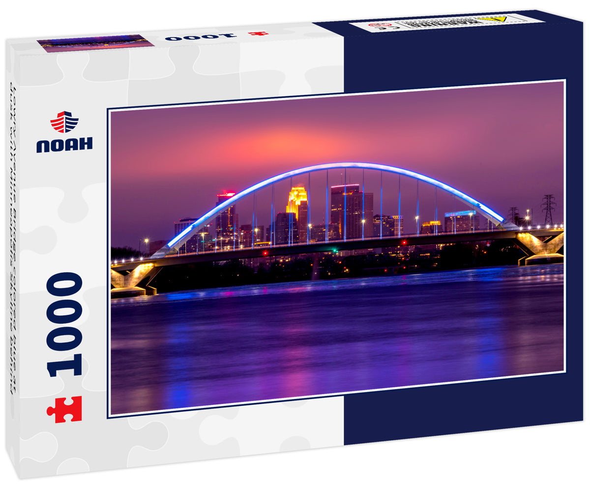 Lowry Avenue Bridge colored blue at dusk with Minneapolis Skyline behind