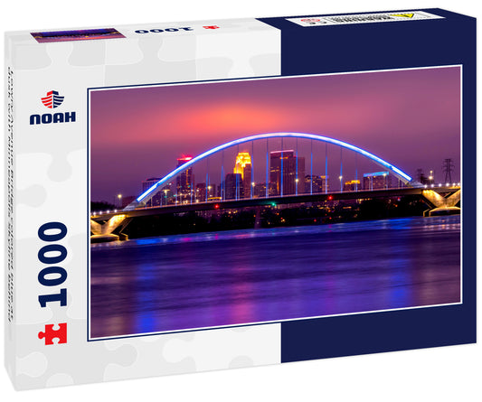 Lowry Avenue Bridge colored blue at dusk with Minneapolis Skyline behind